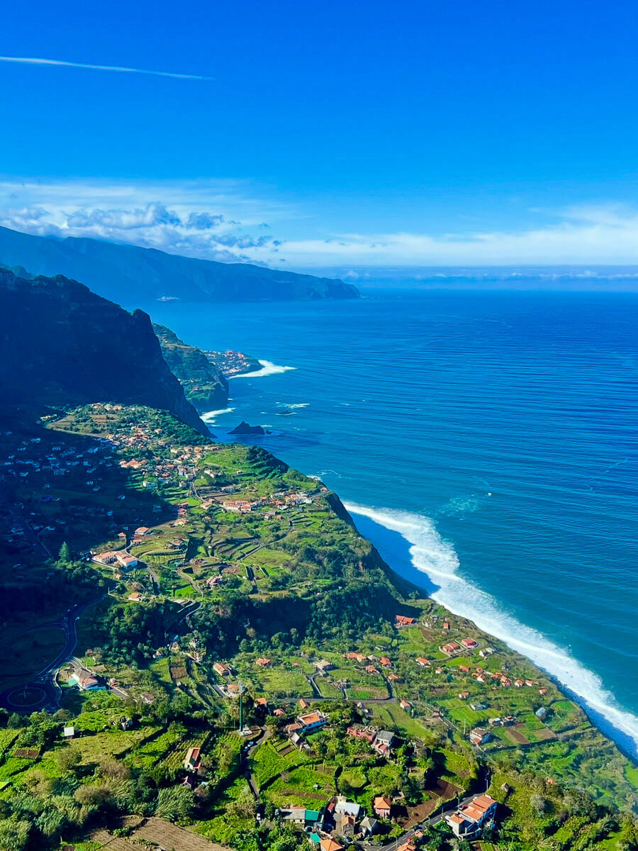 Coast view with small villages and ocean, blue sky in the midday sun