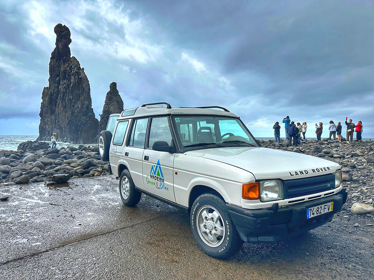 A massive waterfall dropping from a high cliff surrounded by green nature