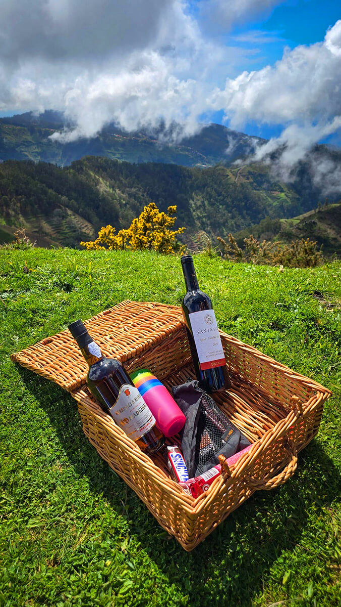 A massive waterfall dropping from a high cliff surrounded by green nature