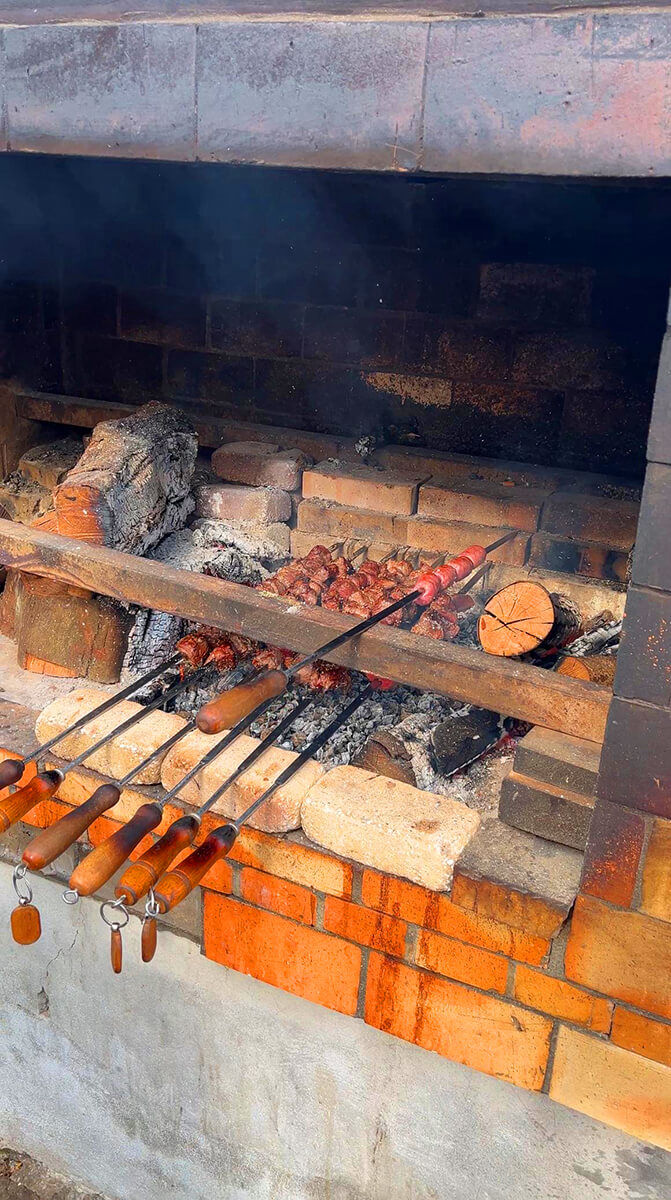 A massive waterfall dropping from a high cliff surrounded by green nature